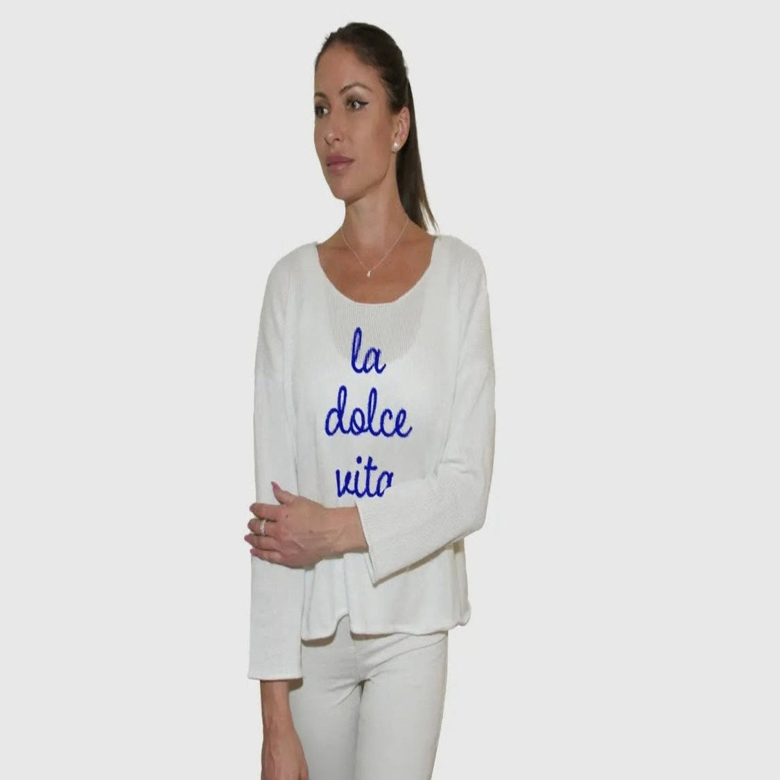 Lightweight cream-colored La Dolce Vita sweater featuring the words 'La Dolce Vita,' perfect for casual Italian flair