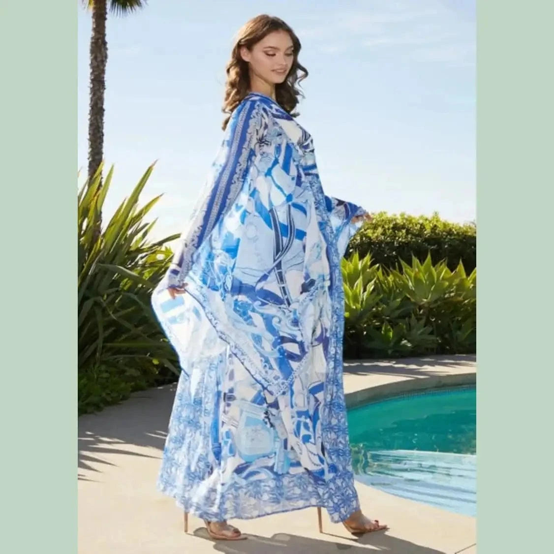 Flowy blue and white pattern maxi dress with a fitted bodice and tired skirt, perfect for summer outings or coastal getaways