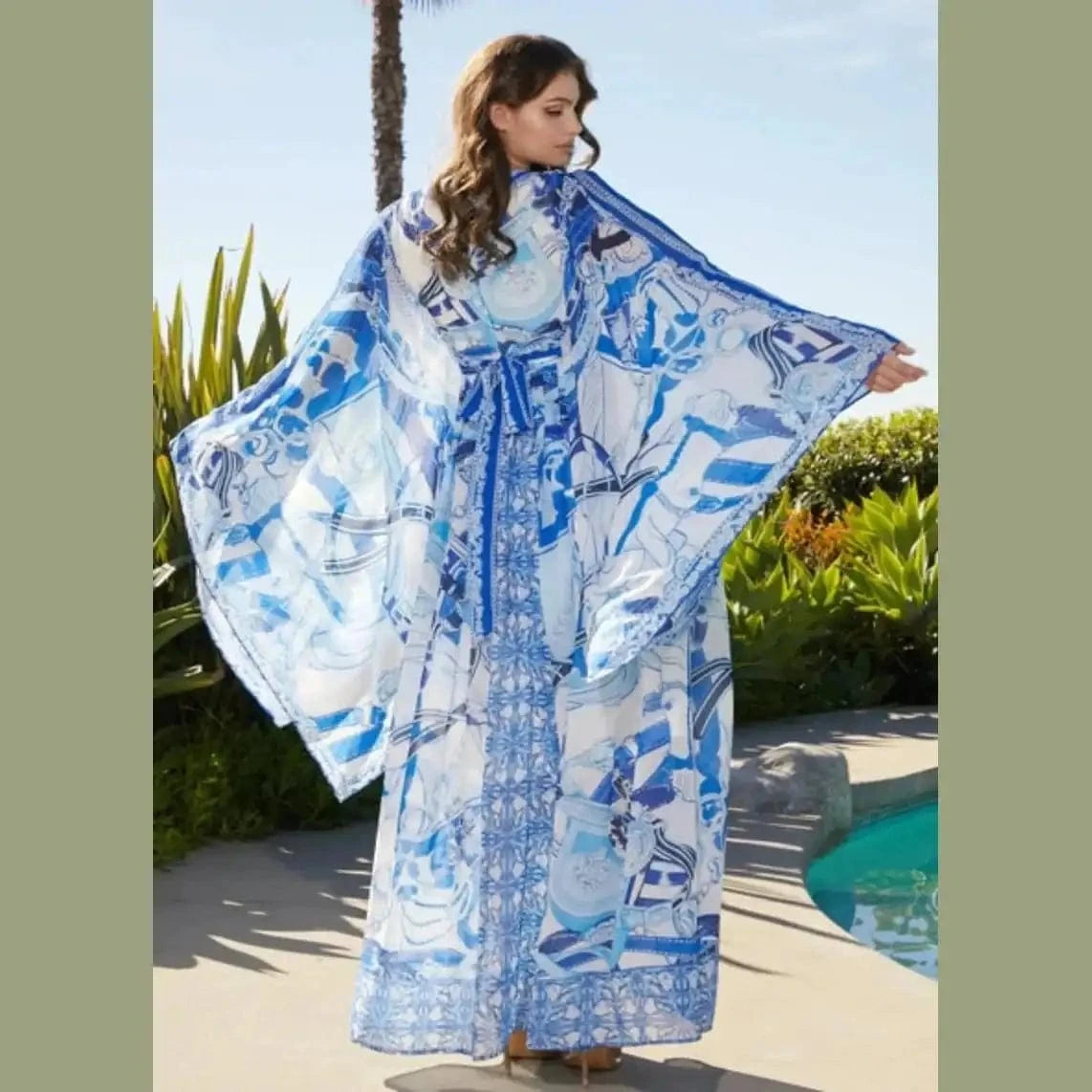 Flowy blue and white pattern maxi dress with a fitted bodice and tired skirt, perfect for summer outings or coastal getaways