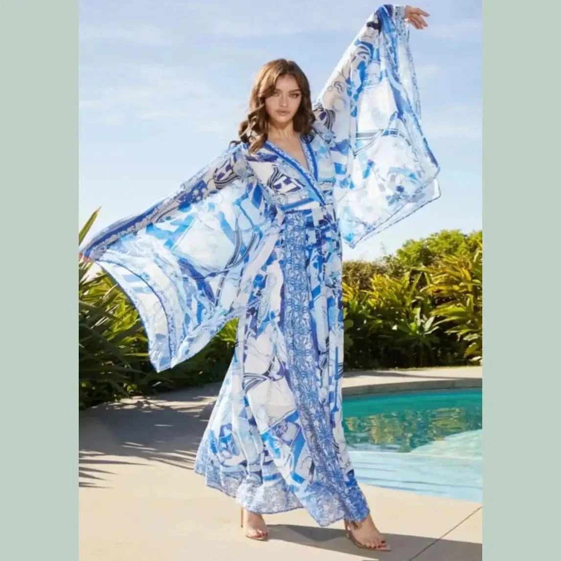 Flowy blue and white pattern maxi dress with a fitted bodice and tired skirt, perfect for summer outings or coastal getaways