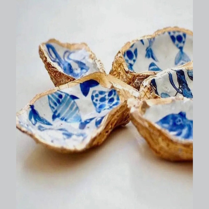 Hand-painted ceramic fish-shaped jewelry dish featuring abstract blue coastal designs, and gold trim evoking the charm of the Amalfi Coast