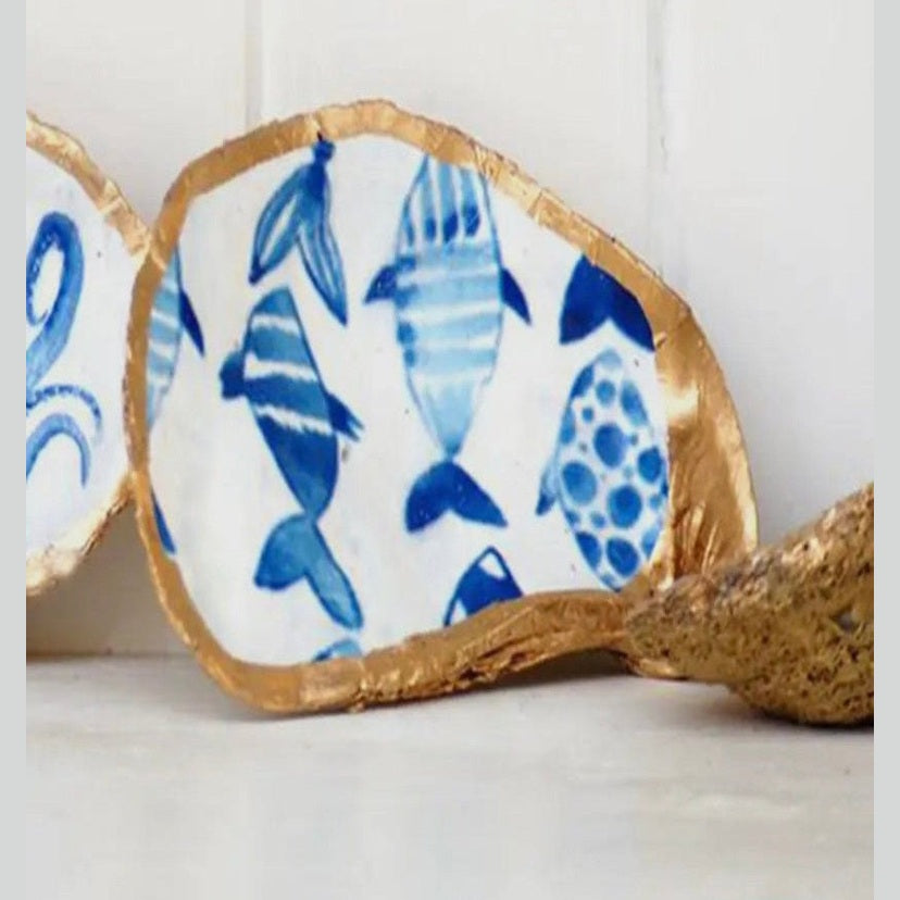 Hand-painted ceramic fish-shaped jewelry dish featuring abstract blue coastal designs, and gold trim evoking the charm of the Amalfi Coast