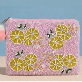Pink pouch with lemon pattern on a blue background