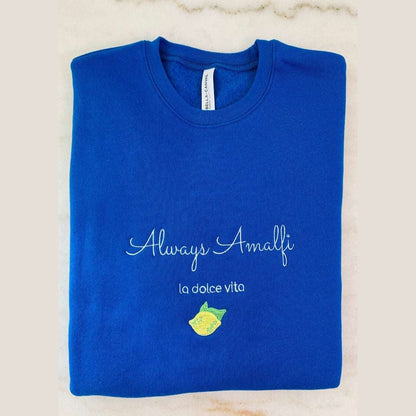 Cream-colored Always Amalfi unisex sweatshirt with classic logo graphic, cozy and stylish Italian-inspired apparel