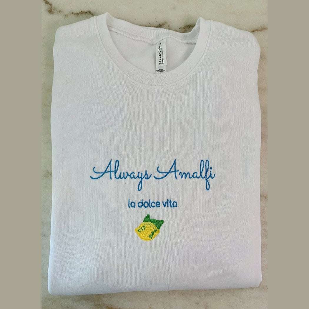 Cream-colored Always Amalfi unisex sweatshirt with classic logo graphic, cozy and stylish Italian-inspired apparel