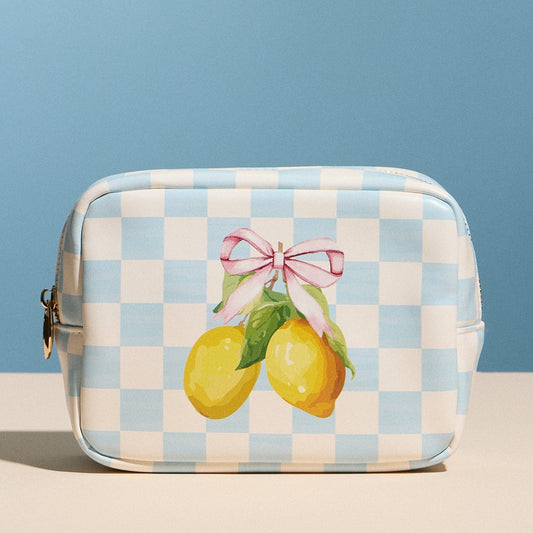 Checkered bag with lemons and a pink bow on a blue background